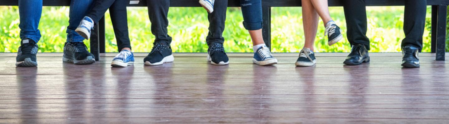 Teens seated with laptop and notebook
