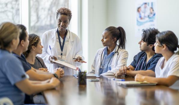 Doctors around at table at a meeting